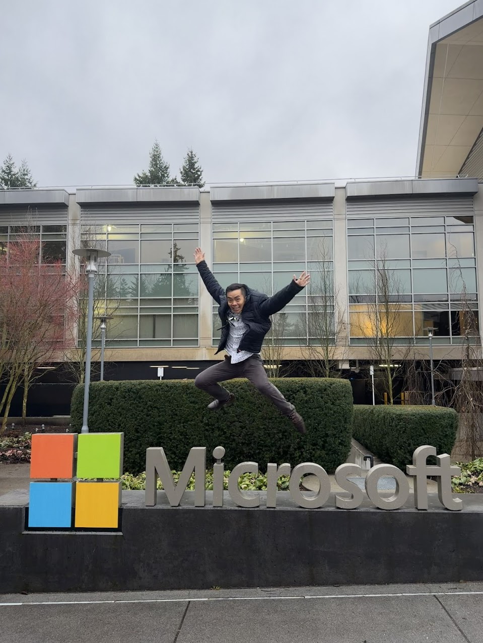 Person jumping over a Microsoft sign